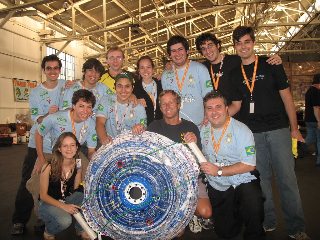 The RioBotz team posing with their big blue spinner robot at RoboGames